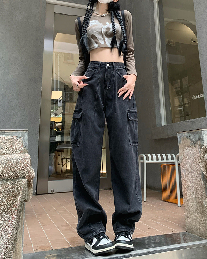 Black wide-leg pants for women with utility pockets, styled with a graphic crop top and sneakers for a modern streetwear vibe.