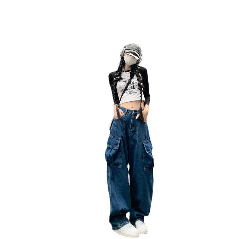 Isolated view of fashionable loose wide-leg denim pants for women with cargo pockets, styled with a crop top and white sneakers.