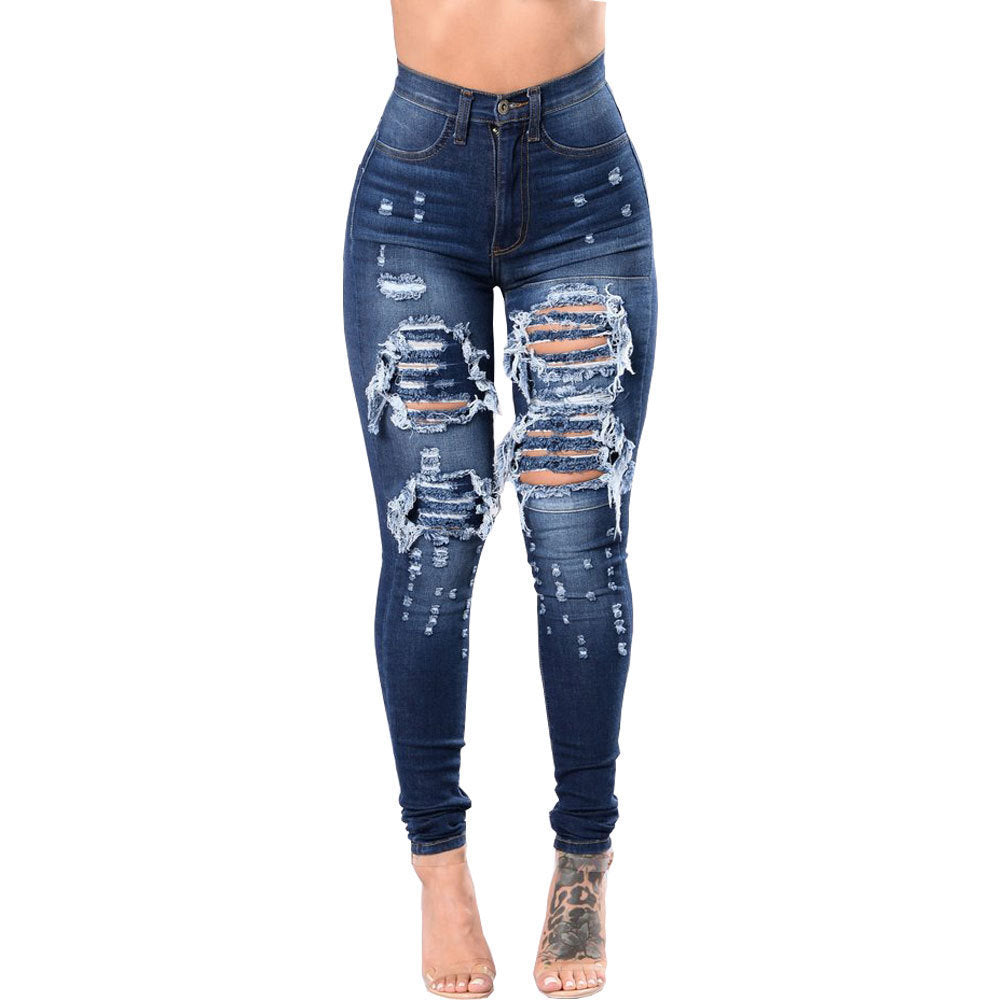 Dark blue ripped jeans for women skinny pants featuring heavy distressing and high-rise fit, ideal for bold casual outfits.