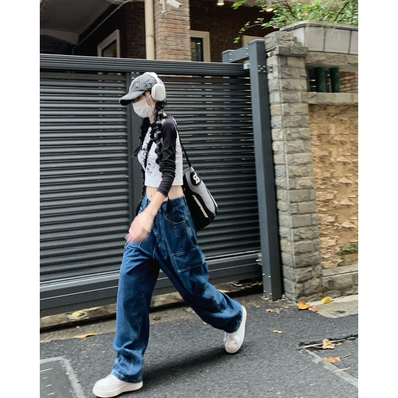 Casual wide-leg denim pants for women styled with a crop top, headphones, and cap, ideal for street fashion and everyday wear.