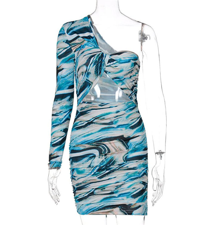Blue-toned womens unilateral sleeve hollow printed dress on mannequin, showcasing asymmetrical sleeve and cut-out front for trendy appeal.