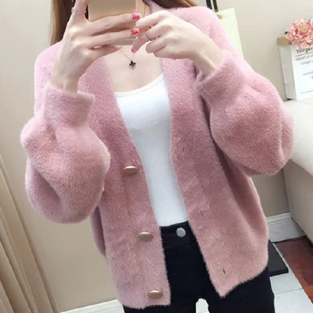 Fashionable knitted short loose outer top for women in soft pink, featuring large buttons and cozy texture, ideal for layering in cool seasons.