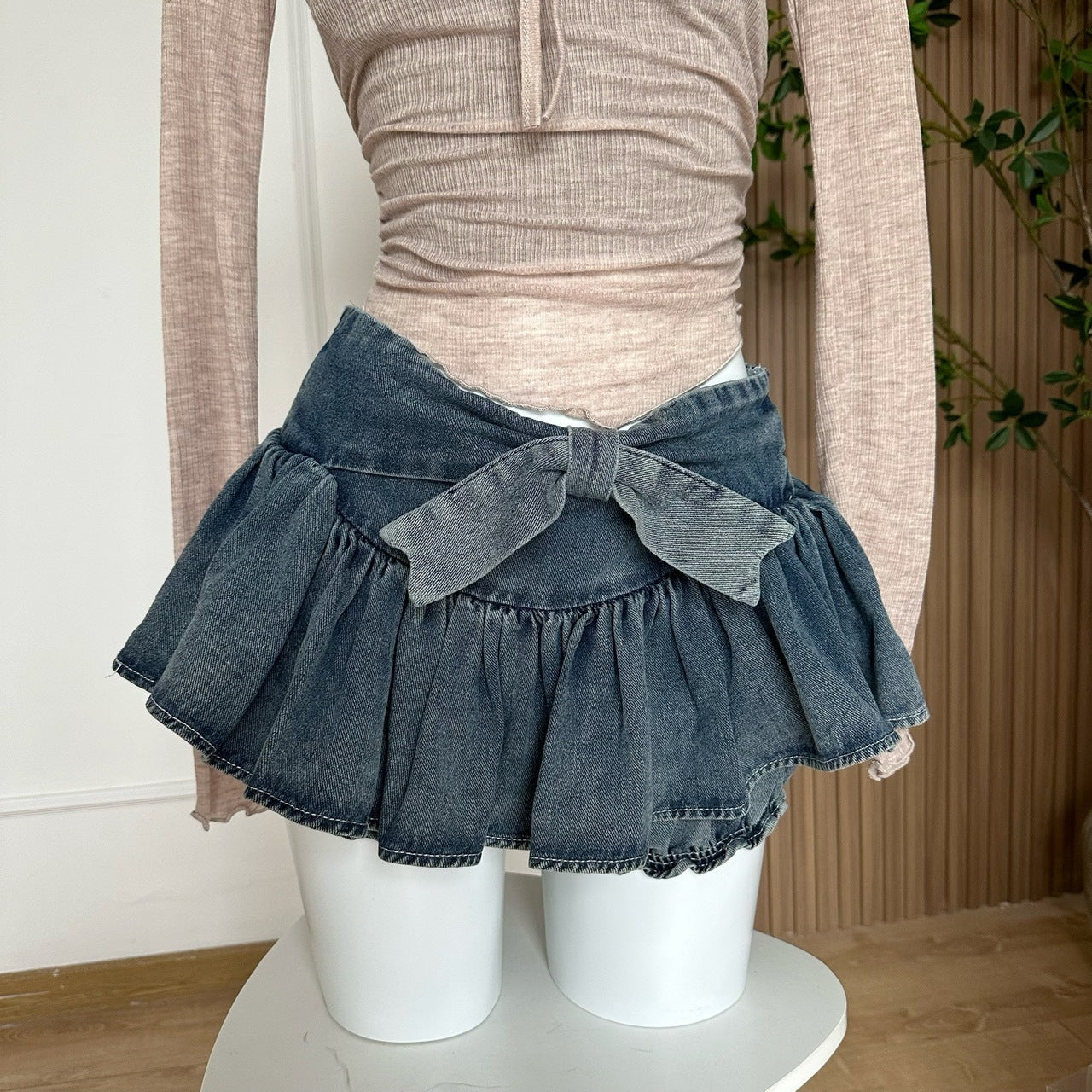 Butterfly Denim Skirt For Women displayed on a mannequin, highlighting the flared ruffle hem and bow-tied waistband design.
