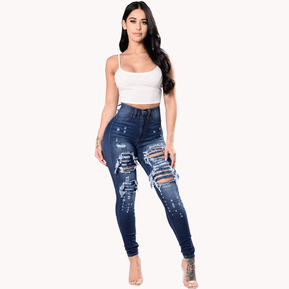 High-waisted dark blue ripped jeans for women skinny pants styled with a white crop top, perfect for modern fashion-forward wear.